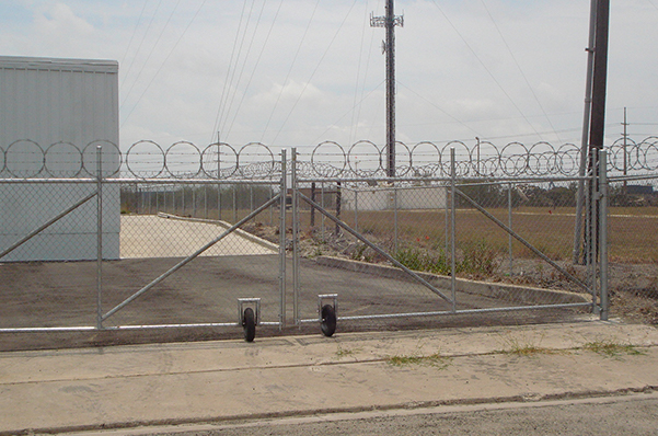 Outdoor chain link fence with barbed wire