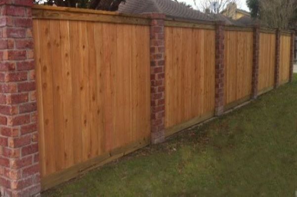 Outdoor wood fence with brick columns in Corpus Christi, TX