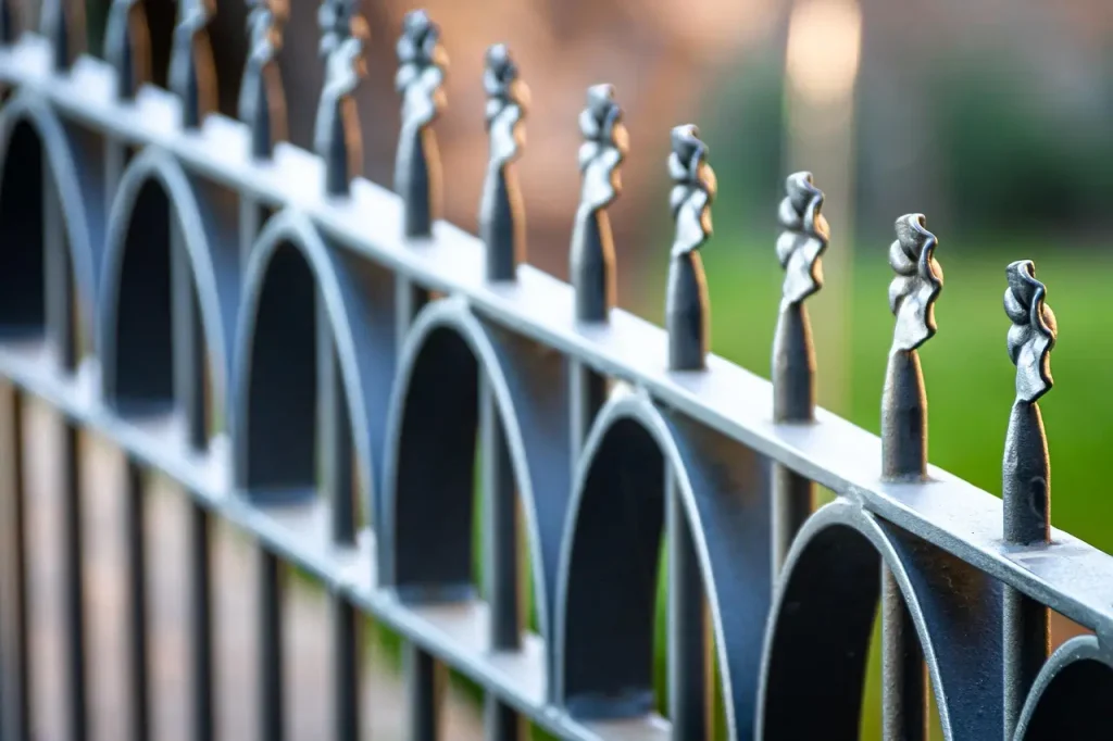 Wrought iron fence with leaf design on top